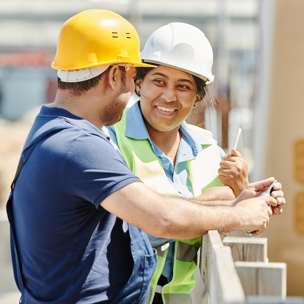 a woman contractor speaking with a peer